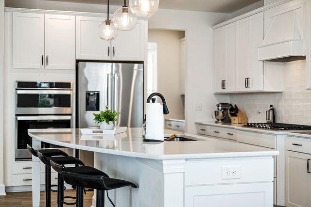 a modern kitchen with a large white island